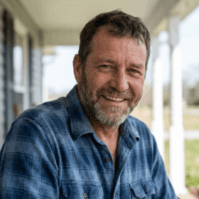 Synaptigen customer review profile photo of a smiling middle-aged man with a beard sharing a testimonial.